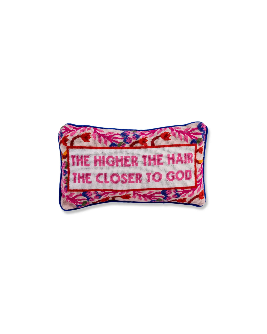 A rectangular pillow with a floral pattern in pink and white, and text that reads 'THE HIGHER THE HAIR, THE CLOSER TO GOD'.