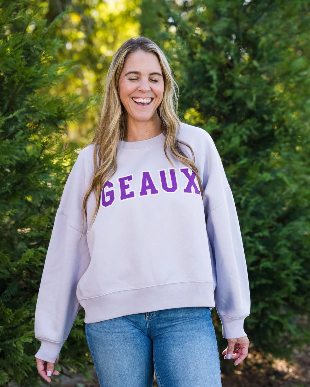 Laughing model in the Geaux Block Cropped Sweatshirt, a Louisiana gameday sweatshirt by Sweet Baton Rouge