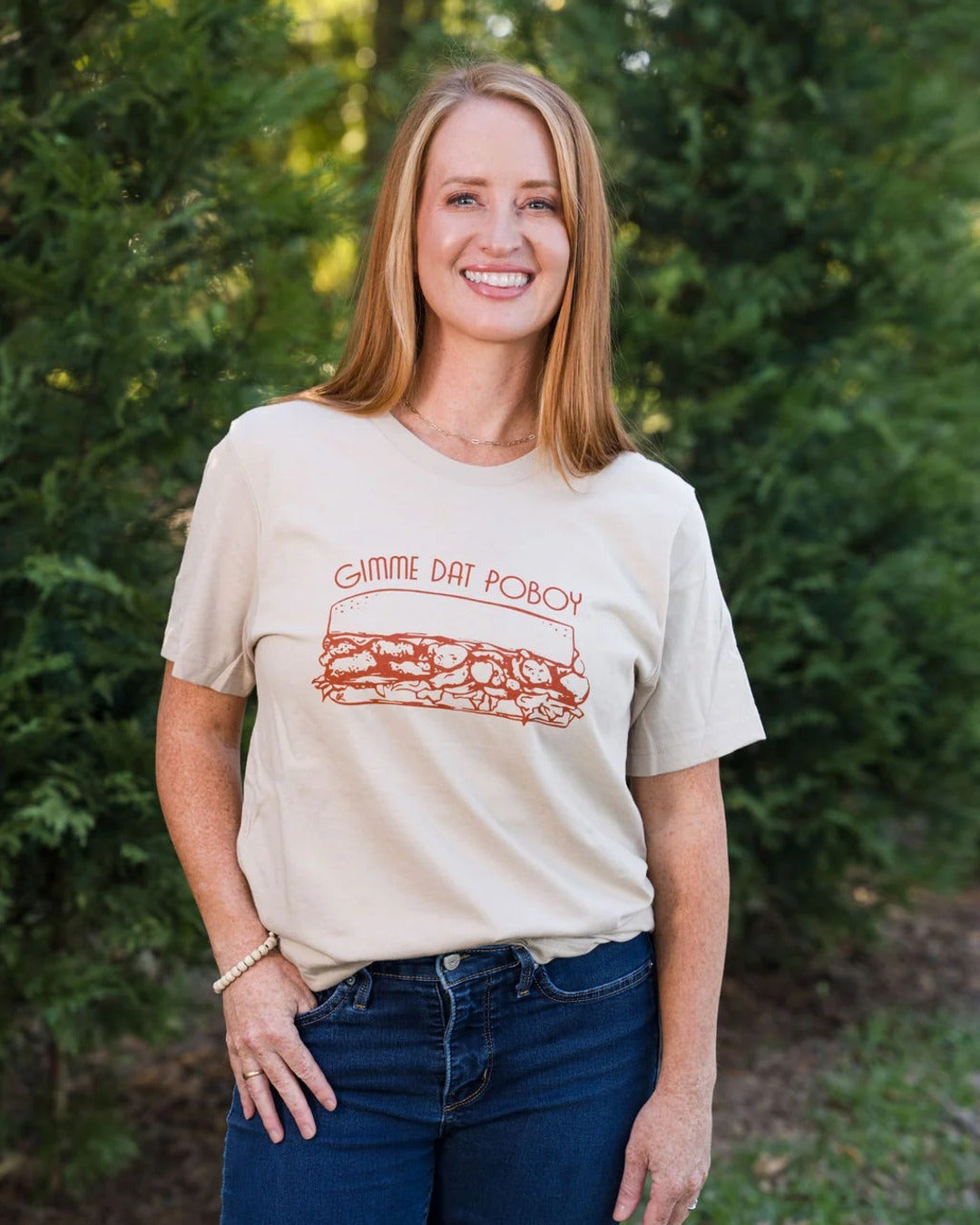 Gimme Dat Poboy T-Shirt in tan, unisex fit, styled with dark jeans outdoors