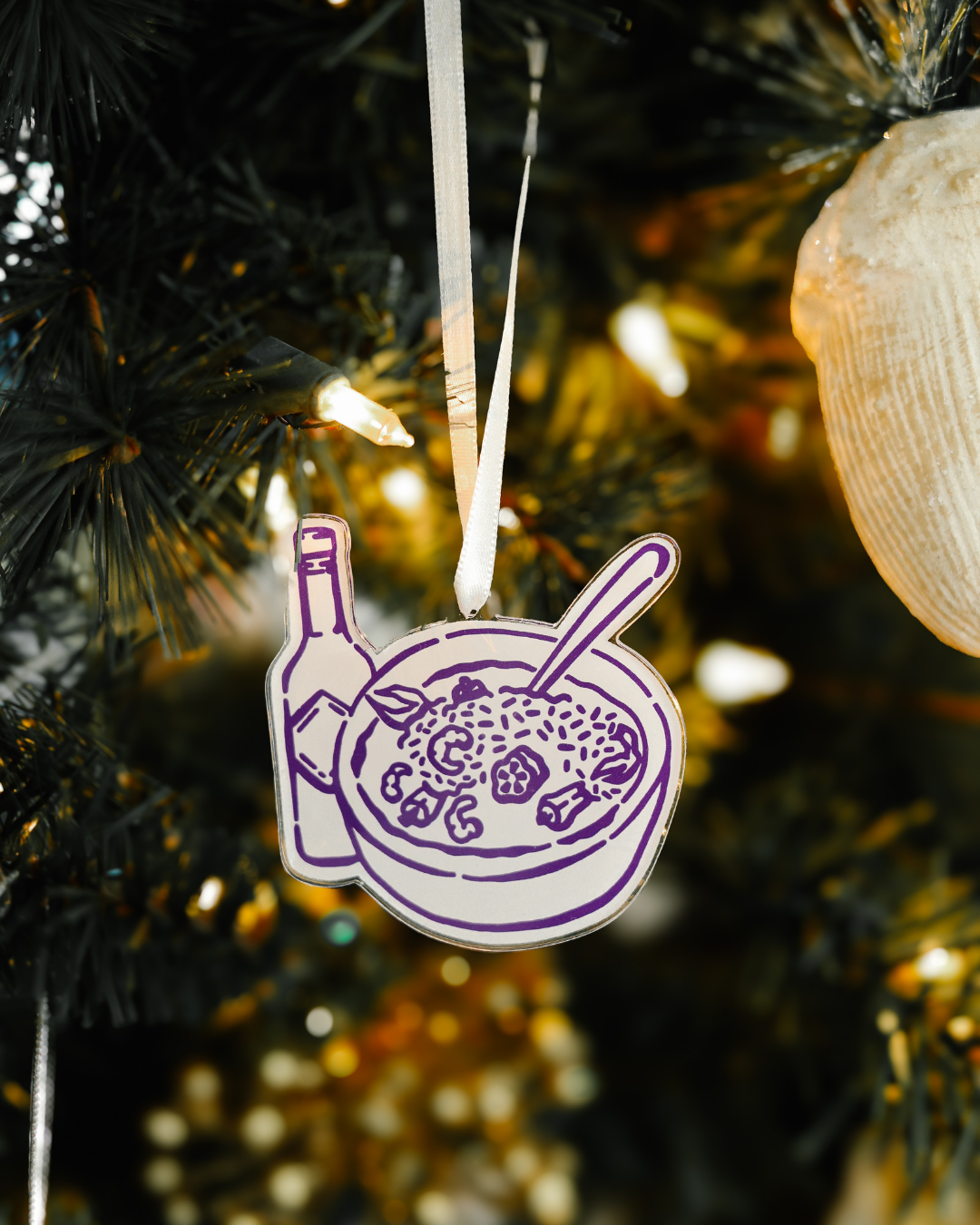 Sweet Baton Rouge purple gumbo and hot sauce icon ornament hanging on a Christmas tree