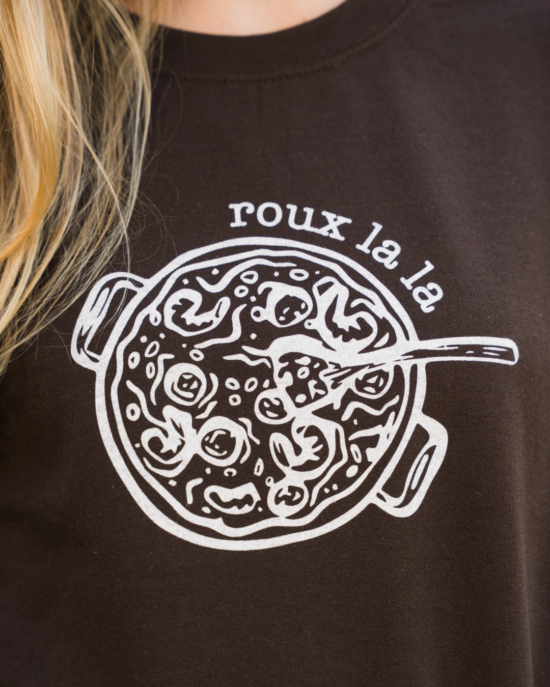 Close-up of the roux la la gumbo pot screen print on the dark chocolate sweatshirt