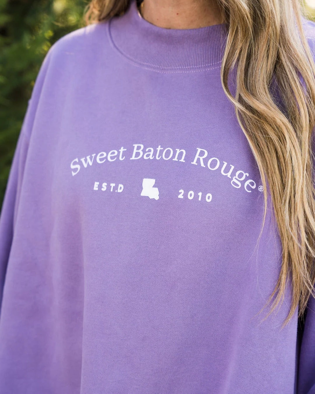Close-up of the Sweet Baton Rouge ESTD 2010 Louisiana design and mock neckline on the lavender sweatshirt