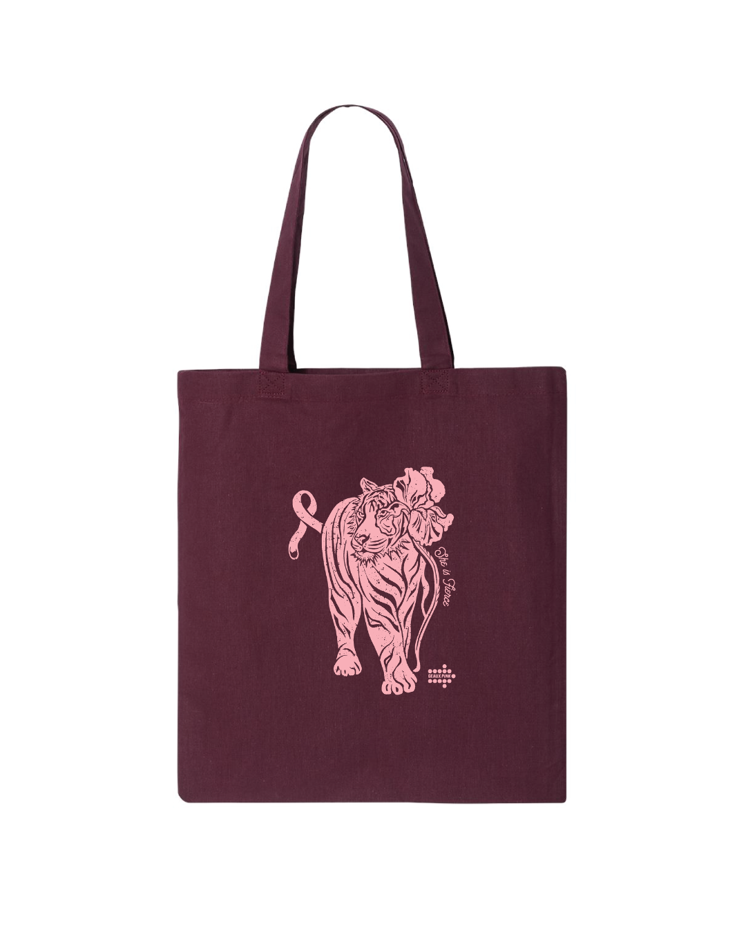 A dark burgundy canvas tote bag with a pink line art illustration of a tiger and a small cross on the front, set against a plain white background.
